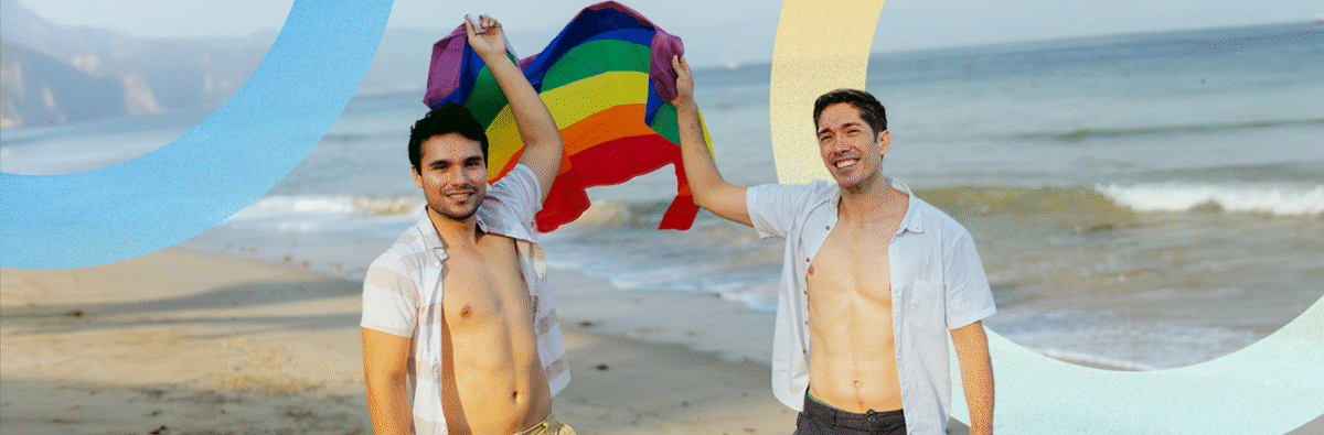 couple-holding-pride-flag-on-beach