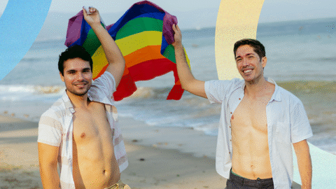 couple-holding-pride-flag-on-beach