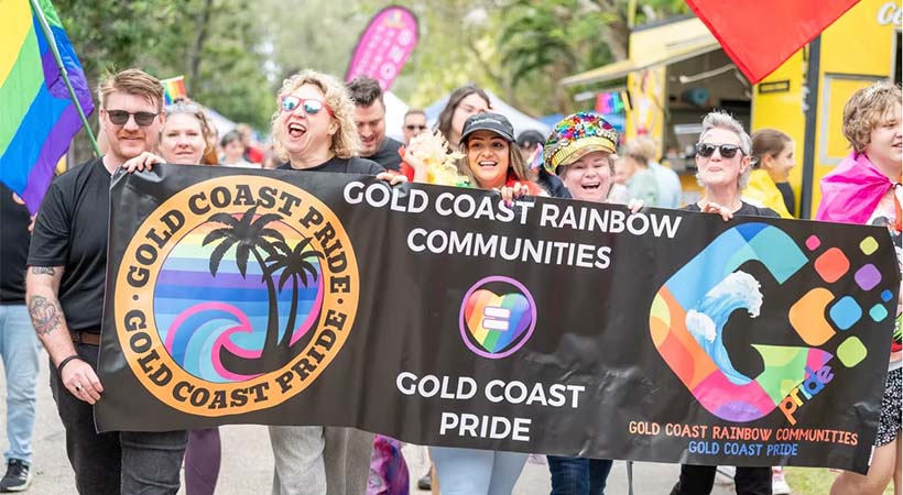 Community members holding a banner for Gold Coast Pride March