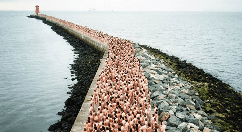 Hundreds of naked people on a wharf