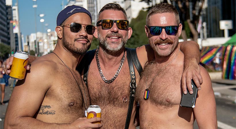 Three hairy guys in sunglasses at pride