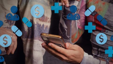 Male hand holding phone, shwoing friends. Blue health emoji in semi-circle