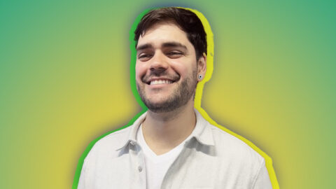 Brazilian man smiling on green and yellow background