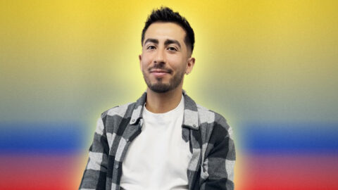 Colombian man smiling on colombian flag background