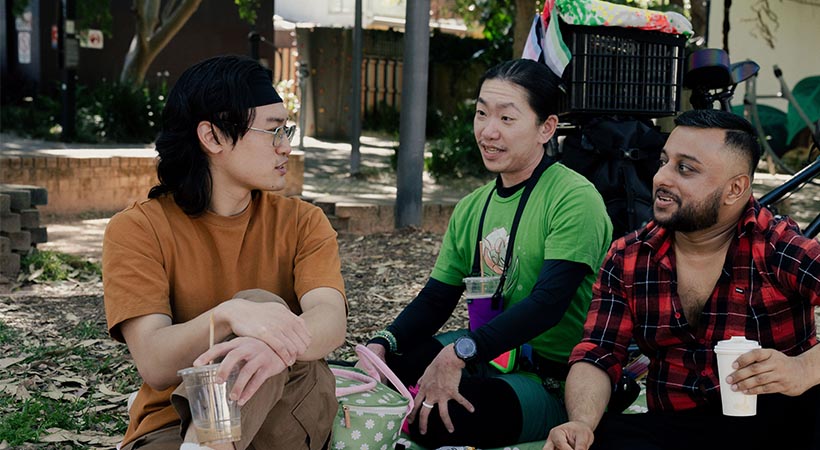 Three friends having a picnic in the park