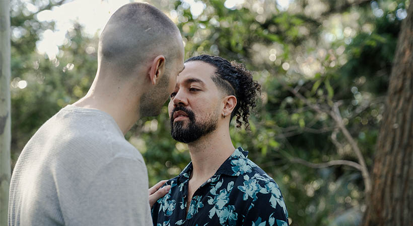 Colombian couple kissing in park 