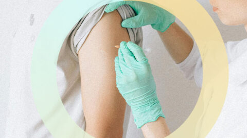 Female doctor giving male patient an injection. Blue and yellow circle graphic